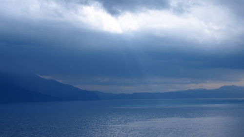 Scenic view of mountains against cloudy sky