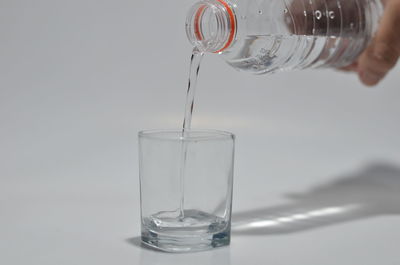 Close-up of glass pouring water