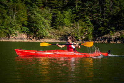 Boat in lake against trees