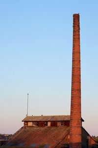 Low angle view of historical building against clear blue sky