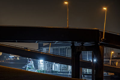 Low angle view of illuminated bridge against sky at night