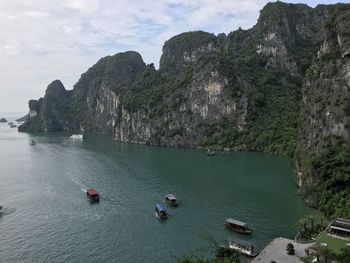 Scenic view of sea and mountains against sky