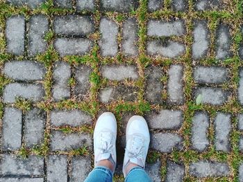 Low section of person standing on footpath