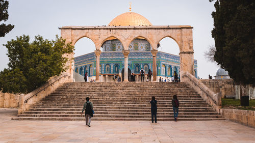 People by mosque in city