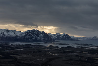 Scenic view of snowcapped mountains against sky during sunset