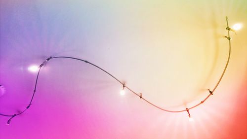 Low angle view of illuminated street light against sky during sunset