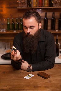 Side view of man playing with toy blocks on table