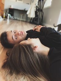 Couple lying on floor at home