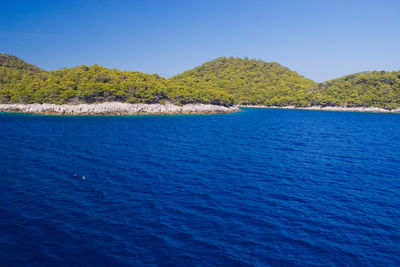 Scenic view of sea against clear blue sky