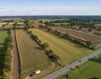 Corn harvest, corn forage harvester in action, harvest truck with tractor