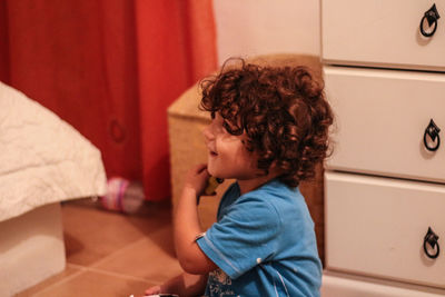 Side view of boy looking at home