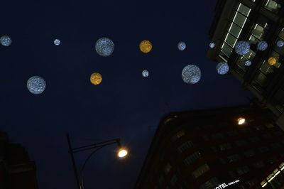 Low angle view of modern building against sky at night