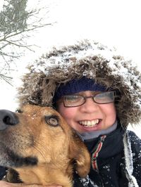 Portrait of smiling young woman in snow