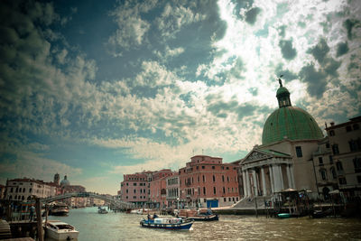 Boats in river with buildings in background