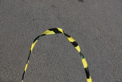 High angle view of yellow road sign on street