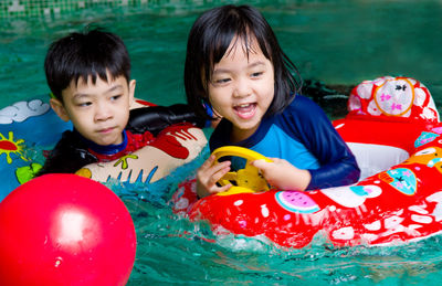 Sister and brother in swimming pool
