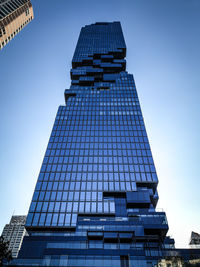 Low angle view of modern building against blue sky