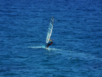 High angle view of man windsurfing on sea