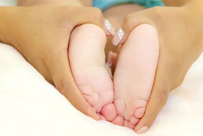 Woman holding baby foot