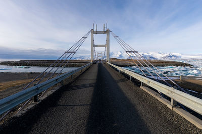 View of bridge over calm sea against sky