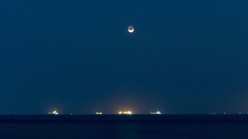 Scenic view of sea against clear sky at night