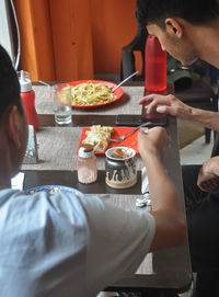 Men eating food at restaurant