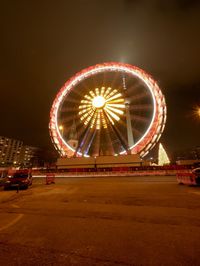 Illuminated ferris wheel at night