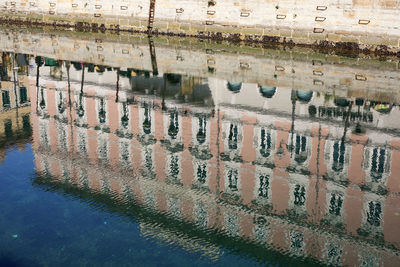 Reflection of building in puddle