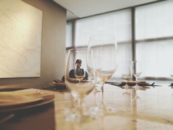 Man sitting in restaurant seen through glasses