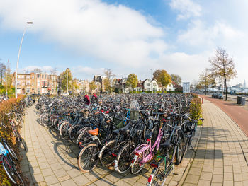 Bicycles parked against sky in city