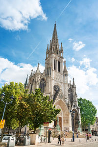 Cathedral against sky in city during sunny day