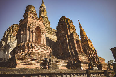 Low angle view of old temple building against clear sky