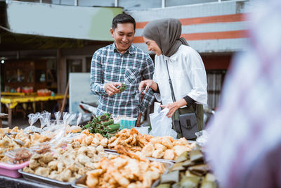 Portrait of man holding food at market