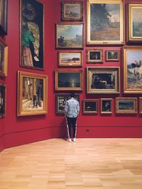 Rear view of man standing in museum