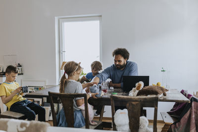 Man working from home and taking care of children