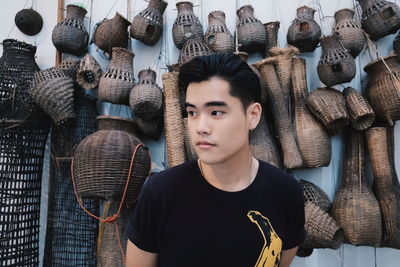 Young man against baskets