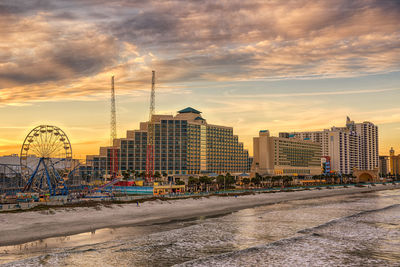 View of buildings against cloudy sky during sunset