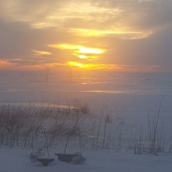 Sun shining through clouds over sea