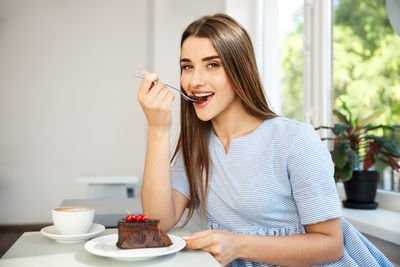 Young woman holding coffee cup