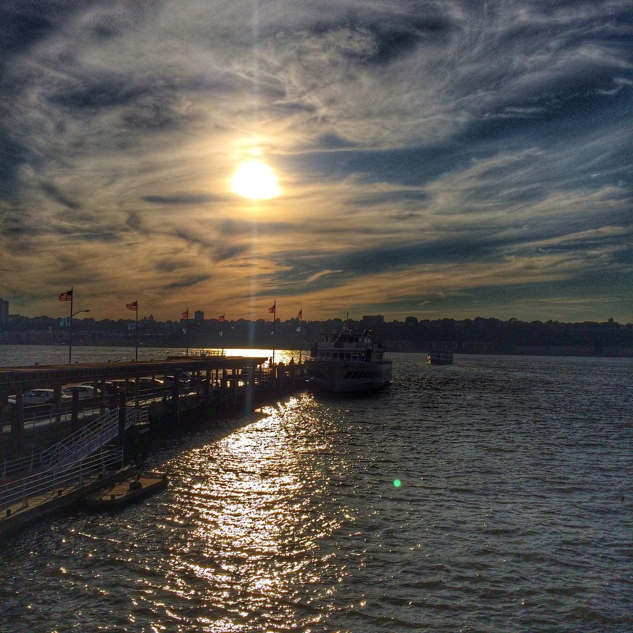 water, sunset, sky, waterfront, sun, cloud - sky, sea, reflection, tranquility, scenics, tranquil scene, rippled, river, beauty in nature, nature, built structure, cloud, cloudy, sunlight, architecture