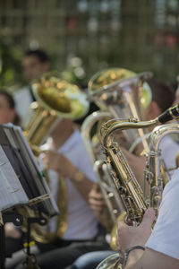 Close-up of people playing trumpet