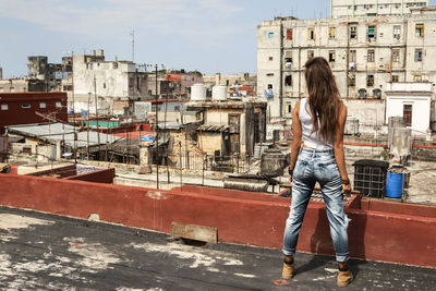 Rear view of woman standing in city