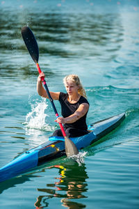 Woman kayaking in lake