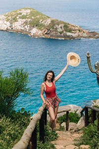 Woman standing against sea