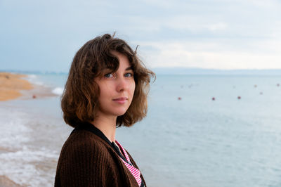 Young woman standing at beach