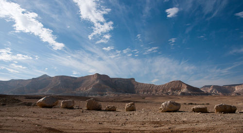 Hay bales on field against sky