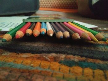 Close-up of multi colored pencils on table