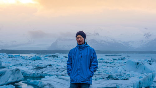 Portrait of man standing at glaciers 