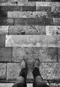 Low section of man standing on footpath