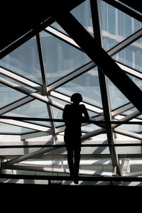 Rear view of silhouette man in modern building